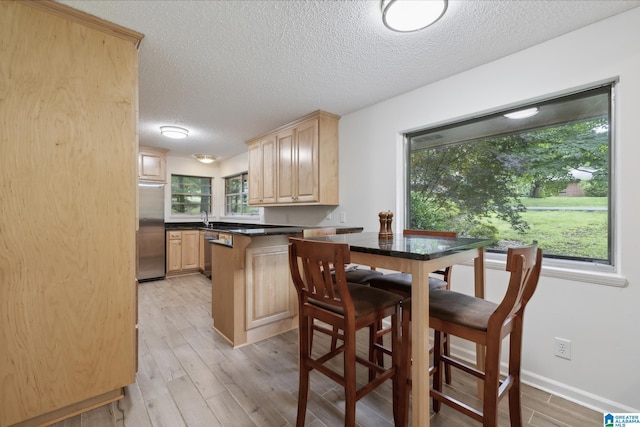 222 Patricia Rd, Madison, AL 35758 - dining space featuring a textured ceiling and light wood-type flooring