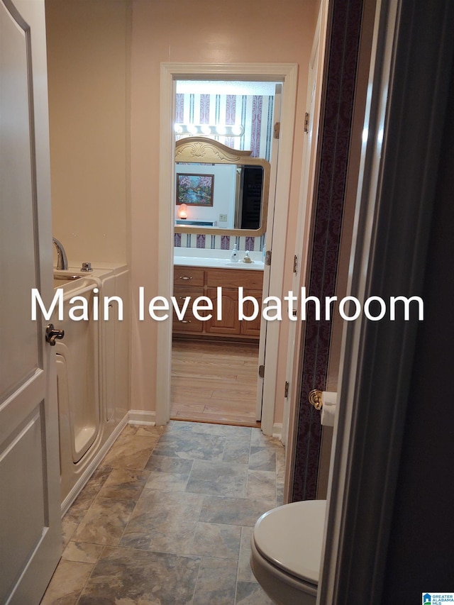 3409 Red Valley Rd, Remlap, AL 35133 - bathroom featuring vanity, toilet, and stone finish floors