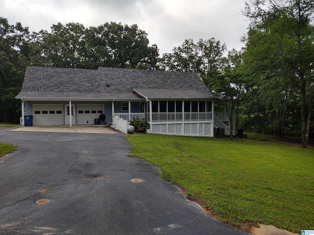 3409 Red Valley Rd, Remlap, AL 35133 - view of front of home featuring asphalt driveway, a front lawn, a garage, a sunroom, and a shingled roof