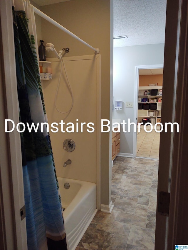 3409 Red Valley Rd, Remlap, AL 35133 - bathroom featuring shower / bath combo, baseboards, and a textured ceiling