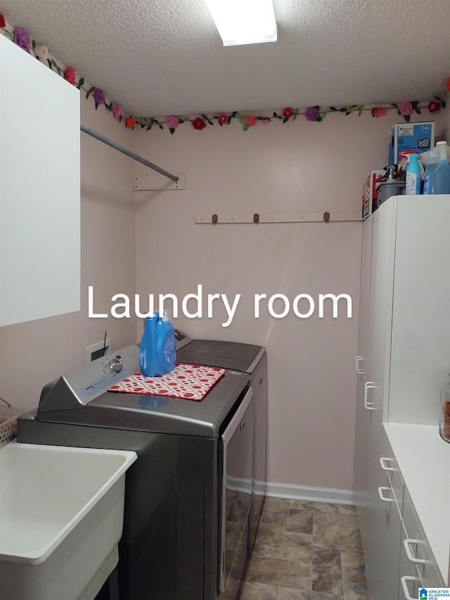 3409 Red Valley Rd, Remlap, AL 35133 - laundry area featuring washer and clothes dryer, a textured ceiling, and baseboards