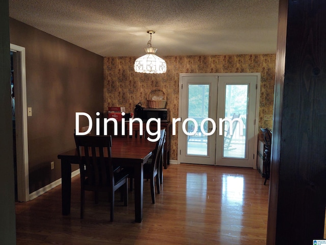 3409 Red Valley Rd, Remlap, AL 35133 - dining space with french doors, baseboards, wood finished floors, and a textured ceiling
