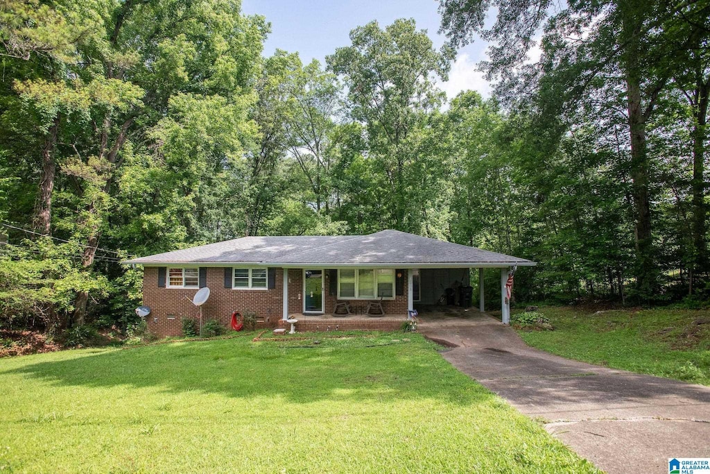 1205 Hillcrest Dr, Weaver, AL 36277 - ranch-style house with asphalt driveway, a front yard, a carport, and brick siding