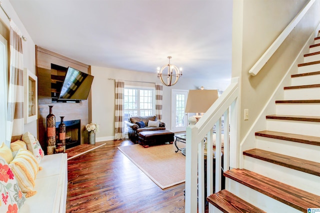 86 Waters Dr, Wedowee, AL 36278 - living area featuring stairs, a chandelier, wood finished floors, a fireplace, and baseboards
