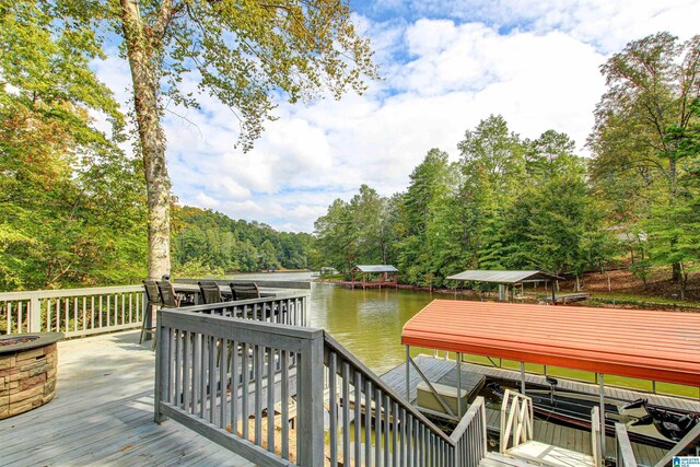 86 Waters Dr, Wedowee, AL 36278 - wooden deck featuring a water view, a dock, boat lift, and a view of trees