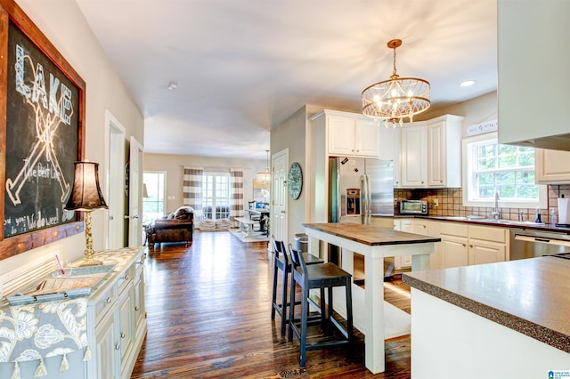 86 Waters Dr, Wedowee, AL 36278 - kitchen with healthy amount of natural light, a sink, dark wood-style floors, stainless steel dishwasher, and recessed lighting