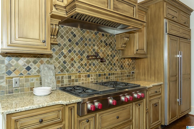 4338 Kings Mountain Rdg, Vestavia Hills, AL 35242 - kitchen featuring custom range hood, paneled built in fridge, backsplash, stainless steel gas stovetop, and light stone countertops