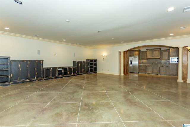 4338 Kings Mountain Rdg, Vestavia Hills, AL 35242 - unfurnished living room featuring arched walkways, crown molding, decorative columns, light tile patterned floors, and recessed lighting