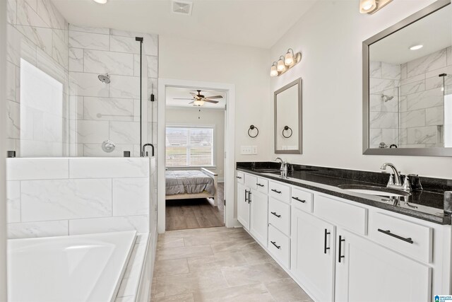 173 Atlantic Ln, Birmingham, AL 35242 - full bathroom featuring a shower stall, double vanity, a ceiling fan, and a bathtub