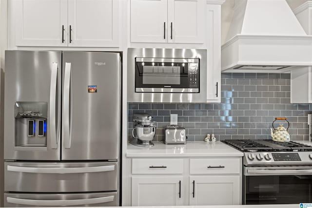 173 Atlantic Ln, Birmingham, AL 35242 - kitchen featuring stainless steel appliances, premium range hood, tasteful backsplash, white cabinetry, and light countertops