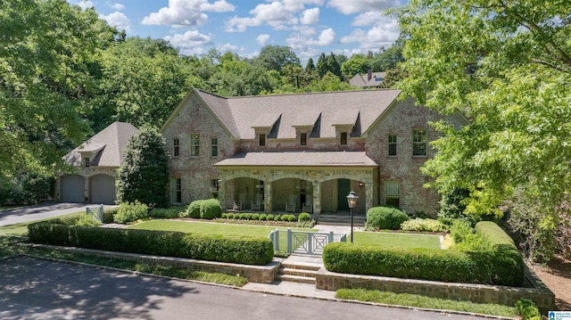 3242 Country Club Rd, Mountain Brook, AL 35213 - view of front facade featuring a porch, driveway, stone siding, brick siding, and a gate