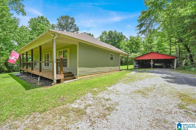 288 Briarfield Rd, Warrior, AL 35180 - view of side of home with a detached carport, driveway, a lawn, a porch, and roof with shingles