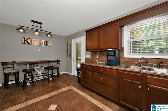 288 Briarfield Rd, Warrior, AL 35180 - kitchen with a sink, healthy amount of natural light, dark tile patterned flooring, and baseboards