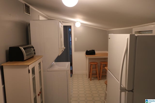 231 Smith Camp Loop, Adger, AL 35006 - kitchen with freestanding refrigerator, light flooring, and wainscoting