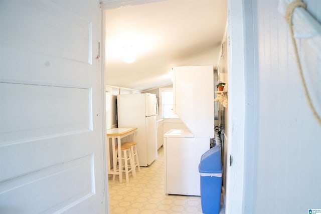 231 Smith Camp Loop, Adger, AL 35006 - laundry room with light floors and stacked washing machine and dryer