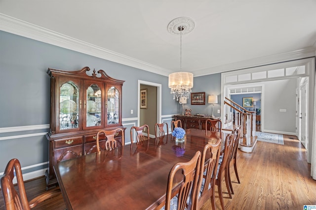 4063 Milners Cres, Hoover, AL 35242 - dining area featuring a chandelier, wood finished floors, ornamental molding, baseboards, and stairway
