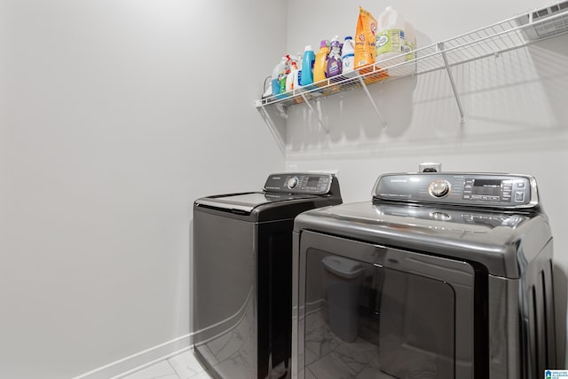 3040 Iris Dr, Hoover, AL 35244 - laundry area featuring marble look tile flooring, separate washer and dryer, and baseboards