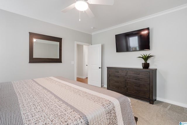 3040 Iris Dr, Hoover, AL 35244 - bedroom with crown molding, light colored carpet, ceiling fan, and baseboards