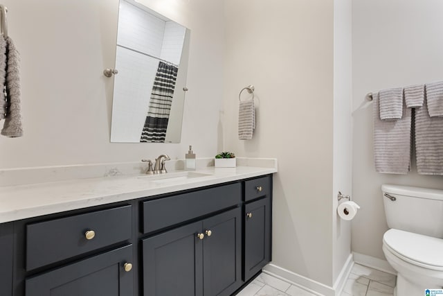 3040 Iris Dr, Hoover, AL 35244 - bathroom featuring vanity, marble look tile flooring, toilet, baseboards, and a shower with shower curtain