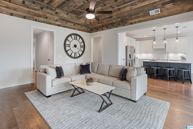 3040 Iris Dr, Hoover, AL 35244 - living room with vaulted ceiling, ceiling fan, dark wood-type flooring, and baseboards