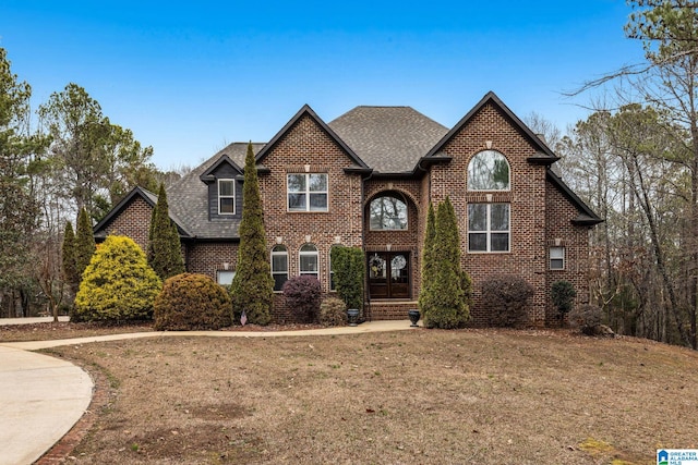 130 Eagle Pointe Way, Pell City, AL 35128 - view of front facade with brick siding, a shingled roof, a front lawn, and french doors
