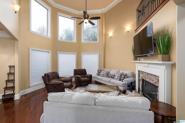 130 Eagle Pointe Way, Pell City, AL 35128 - living room with a ceiling fan, a stone fireplace, dark wood-type flooring, baseboards, and crown molding