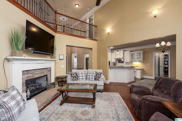 130 Eagle Pointe Way, Pell City, AL 35128 - living room with a towering ceiling, baseboards, a stone fireplace, dark wood-style floors, and crown molding