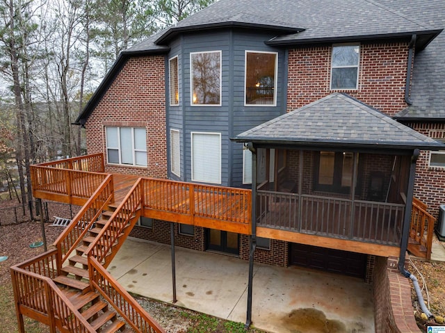 130 Eagle Pointe Way, Pell City, AL 35128 - back of property with stairway, a shingled roof, a patio, a sunroom, and a wooden deck