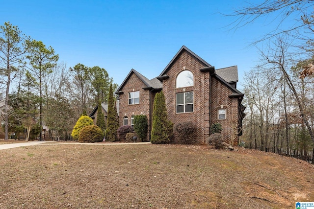 130 Eagle Pointe Way, Pell City, AL 35128 - view of property exterior featuring brick siding and a yard