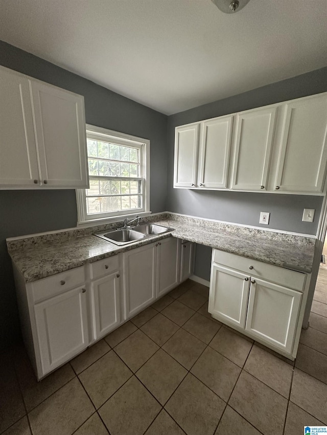 118 3rd Ave SW, Birmingham, AL 35211 - kitchen with a sink, white cabinets, and light tile patterned flooring