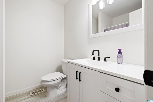 1742 Molly Ln, Birmingham, AL 35235 - full bath featuring vanity, toilet, baseboards, and wood finished floors