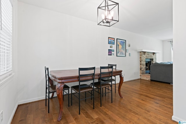 1742 Molly Ln, Birmingham, AL 35235 - dining room with wood finished floors, a chandelier, a fireplace, and baseboards
