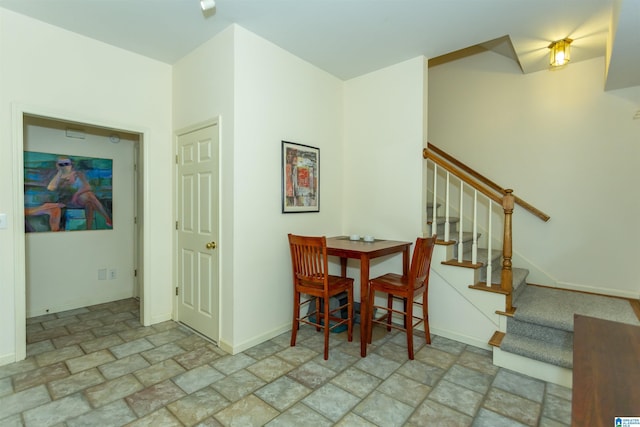 307 N Lake Rd, Hoover, AL 35242 - dining area featuring stone finish flooring, stairway, and baseboards