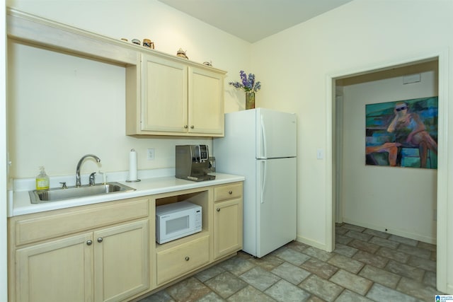 307 N Lake Rd, Hoover, AL 35242 - kitchen with a sink, white appliances, stone finish flooring, light countertops, and baseboards