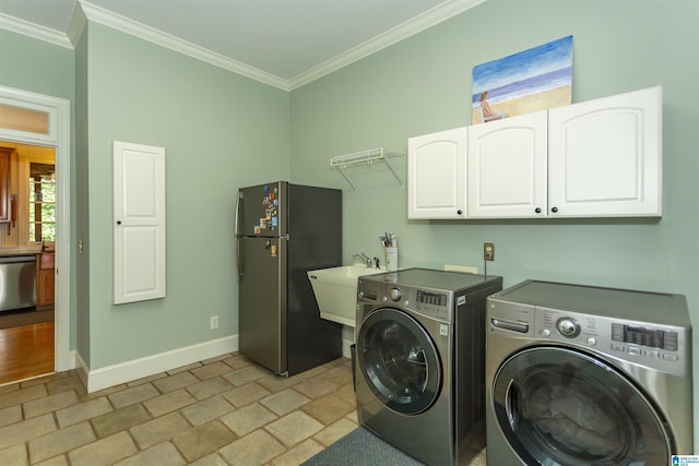 307 N Lake Rd, Hoover, AL 35242 - laundry area featuring cabinet space, independent washer and dryer, ornamental molding, baseboards, and light stone finish flooring