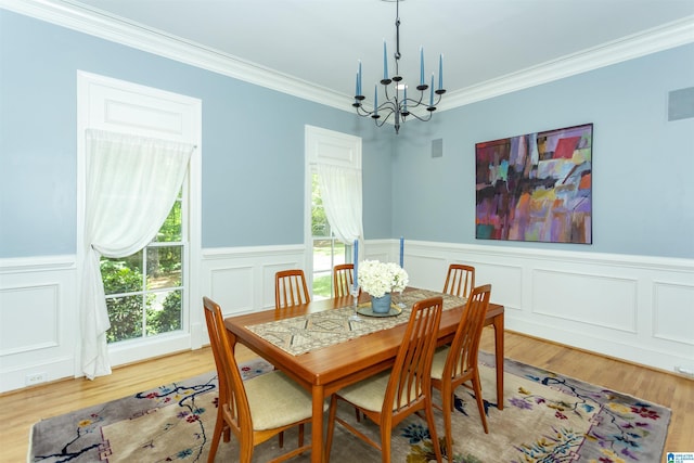 307 N Lake Rd, Hoover, AL 35242 - dining space featuring a chandelier, crown molding, wood finished floors, wainscoting, and a decorative wall
