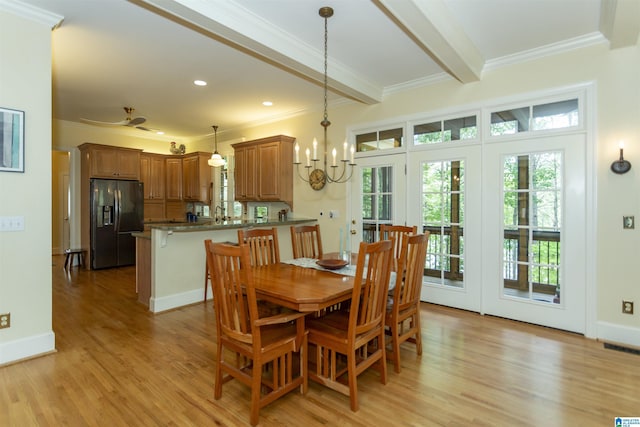 307 N Lake Rd, Hoover, AL 35242 - dining area featuring plenty of natural light, light wood-type flooring, beam ceiling, crown molding, and a chandelier