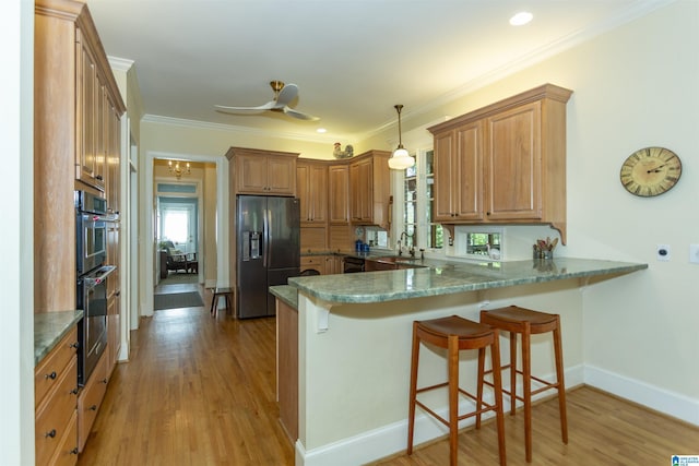 307 N Lake Rd, Hoover, AL 35242 - kitchen featuring refrigerator with ice dispenser, a peninsula, a breakfast bar, light wood-type flooring, and baseboards