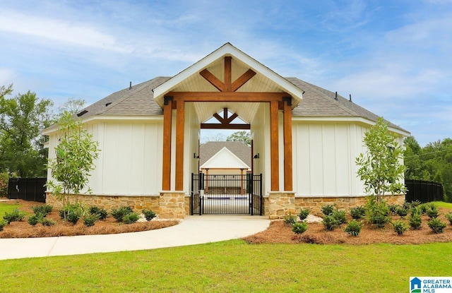217 Halifax Ln, Chelsea, AL 35043 - view of front facade with a gate, stone siding, board and batten siding, and a shingled roof