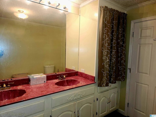 5810 Stemley Bridge Rd, Talladega, AL 35160 - bathroom with double vanity, a textured ceiling, toilet, and crown molding