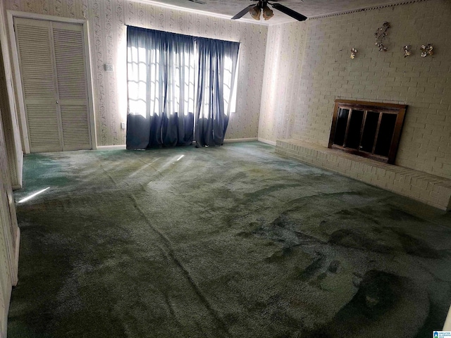 5810 Stemley Bridge Rd, Talladega, AL 35160 - unfurnished living room with carpet, baseboards, ceiling fan, wallpapered walls, and a fireplace