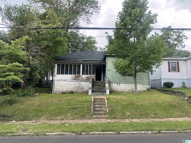 7804 Rugby Ave, Birmingham, AL 35206 - view of front of property featuring a sunroom, a front lawn, and a shingled roof