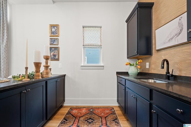 1761 Gable Way, Hoover, AL 35244 - bar area featuring a sink, baseboards, and light wood finished floors