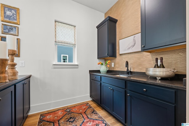 1761 Gable Way, Hoover, AL 35244 - kitchen with a sink, baseboards, light wood-style floors, blue cabinetry, and dark stone counters