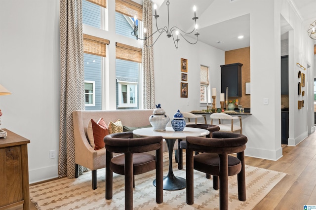 1761 Gable Way, Hoover, AL 35244 - dining area with plenty of natural light, a chandelier, light wood-type flooring, baseboards, and a high ceiling