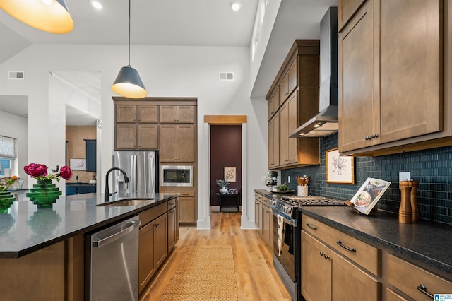 1761 Gable Way, Hoover, AL 35244 - kitchen featuring appliances with stainless steel finishes, wall chimney exhaust hood, a sink, backsplash, and light wood-style flooring