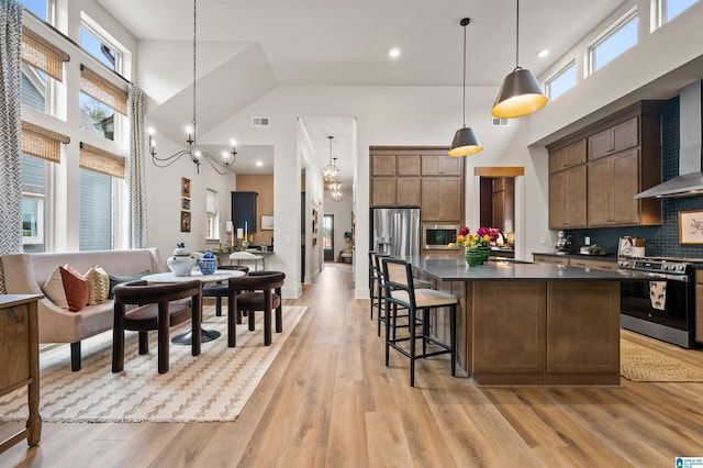 1761 Gable Way, Hoover, AL 35244 - kitchen with stainless steel appliances, high vaulted ceiling, dark countertops, open floor plan, and a chandelier