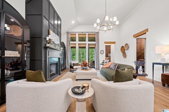 1761 Gable Way, Hoover, AL 35244 - living area featuring a chandelier, light wood-style flooring, a high end fireplace, and high vaulted ceiling