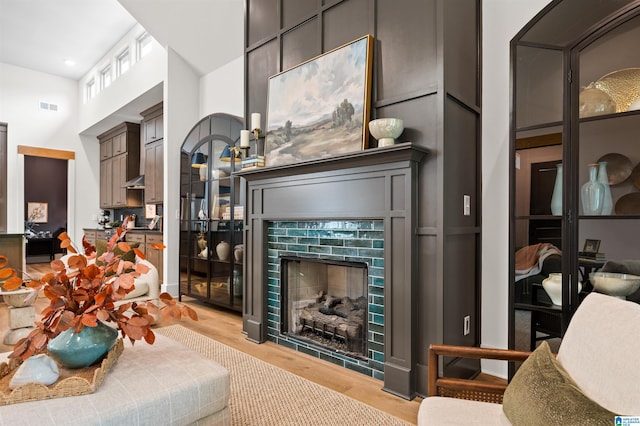 1761 Gable Way, Hoover, AL 35244 - living area with a fireplace, light wood finished floors, and a towering ceiling