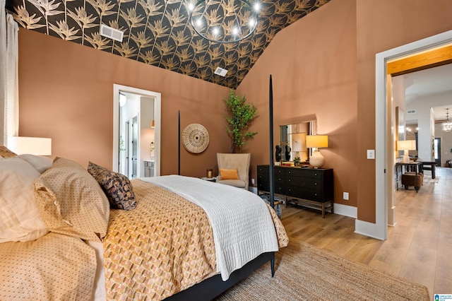 1761 Gable Way, Hoover, AL 35244 - bedroom featuring a chandelier, wood finished floors, high vaulted ceiling, baseboards, and connected bathroom